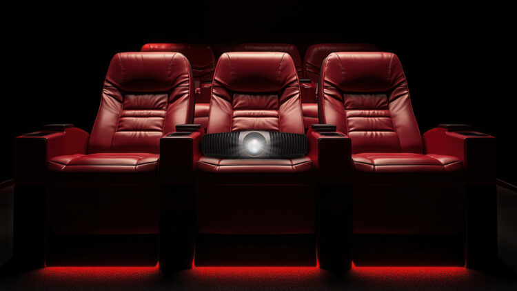 Plush red seats in dark interior of modern home cinema movie theatre room