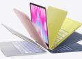 MacBook na stole vedle grafu růstu dodávek Maců
