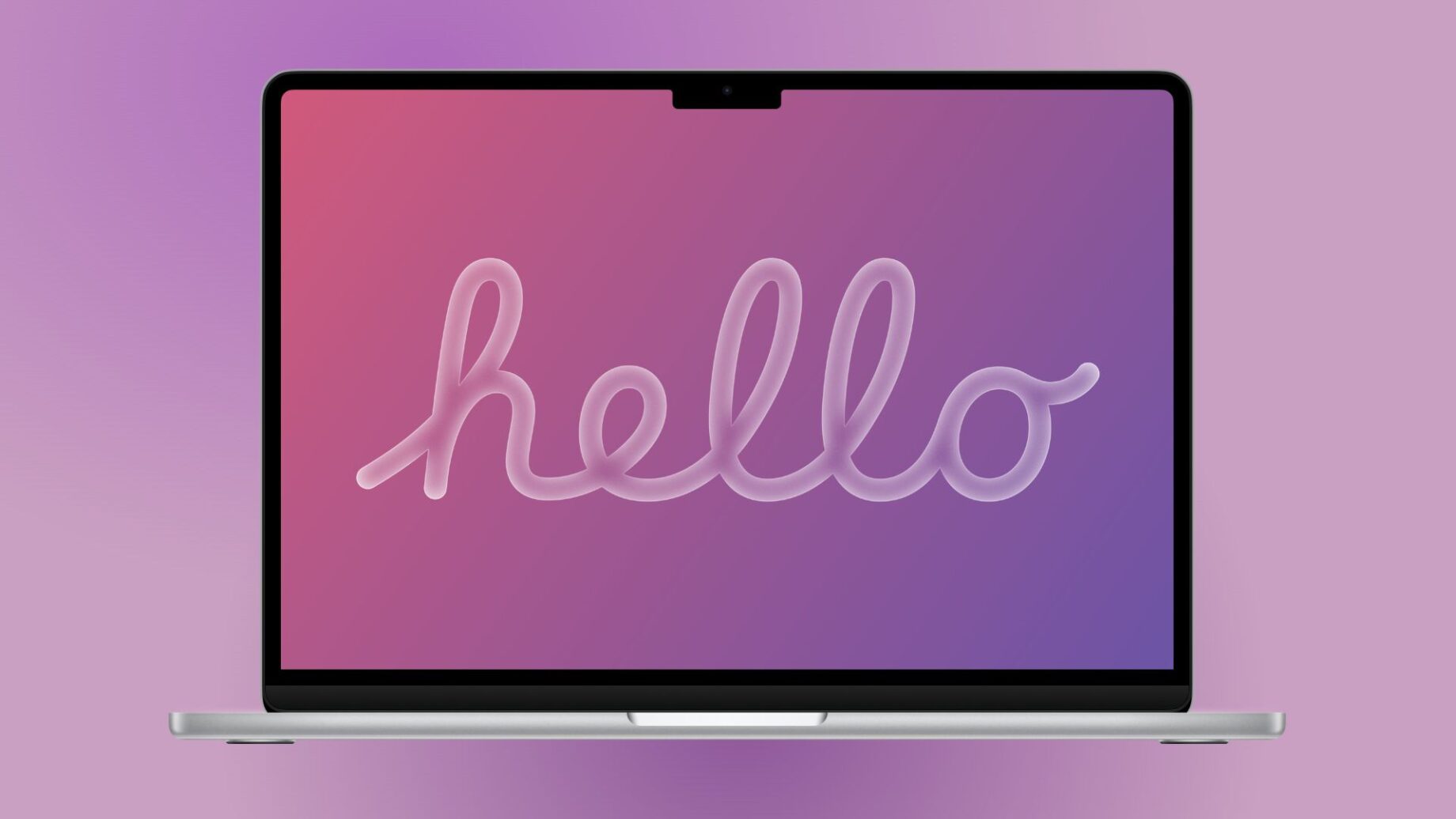 MacBook s OLED displejem na stole